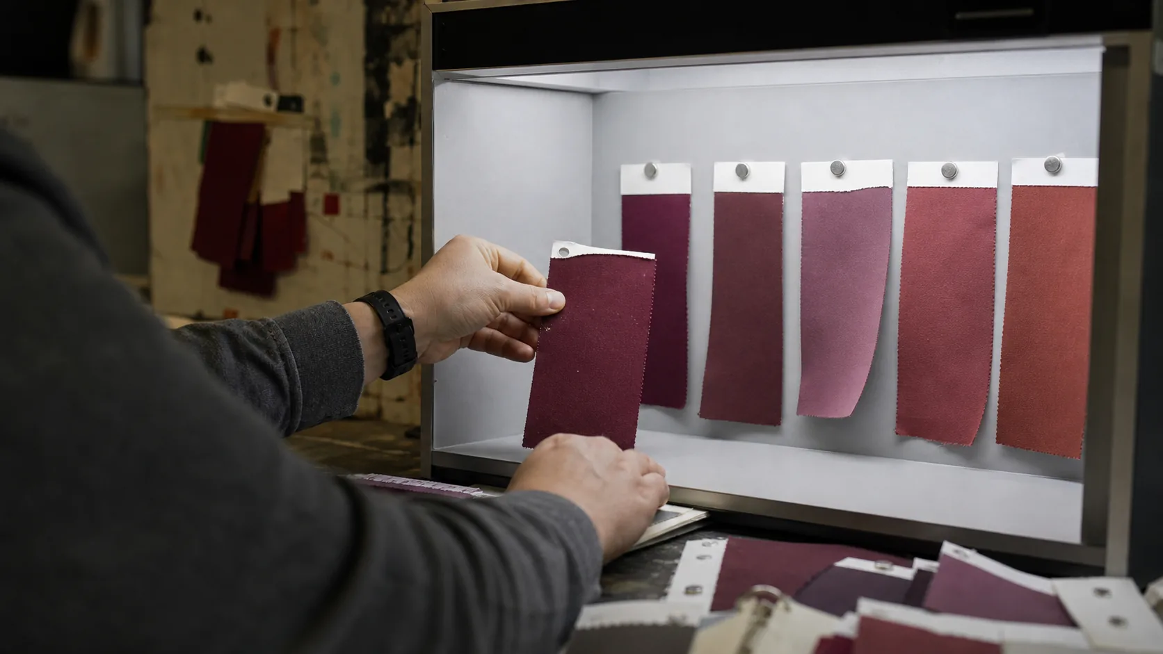 Illustrative fabric shade comparison in a light cabinet