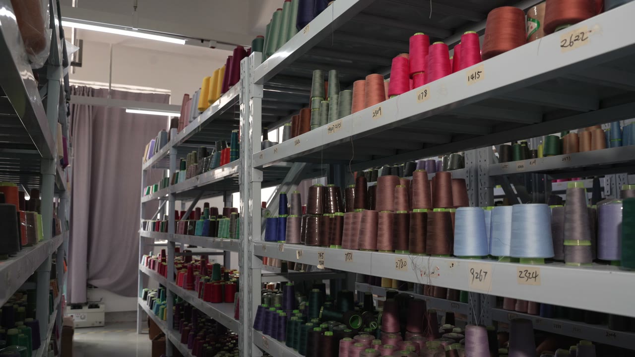 Shelves of colored sewing-thread cones in a materials store