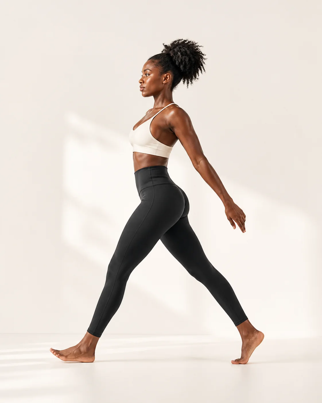 Full-length black high-waist leggings shown in side profile
