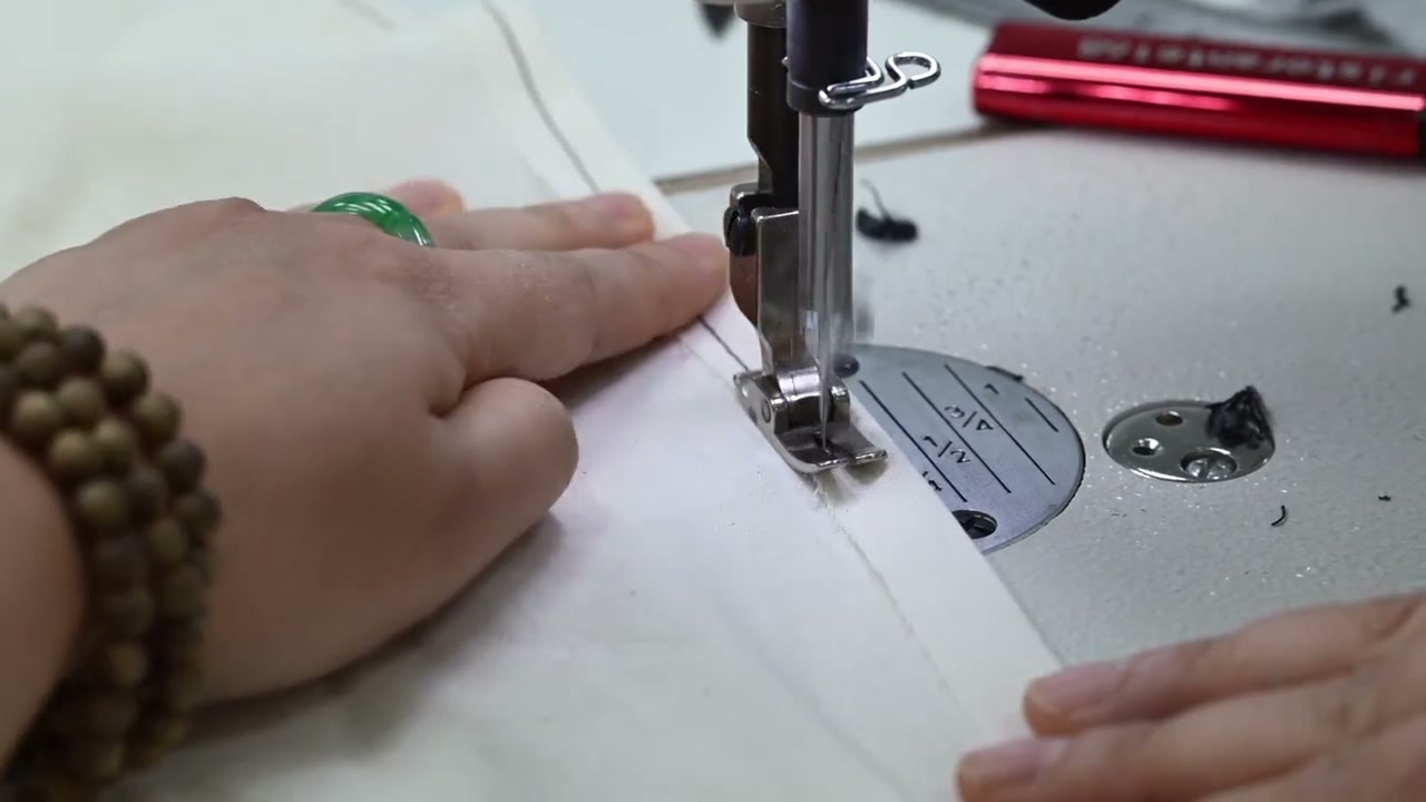 Close view of activewear construction being reviewed at a sewing machine