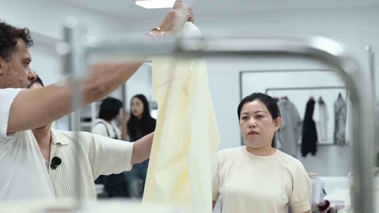 A garment being held up for review in supplied development footage