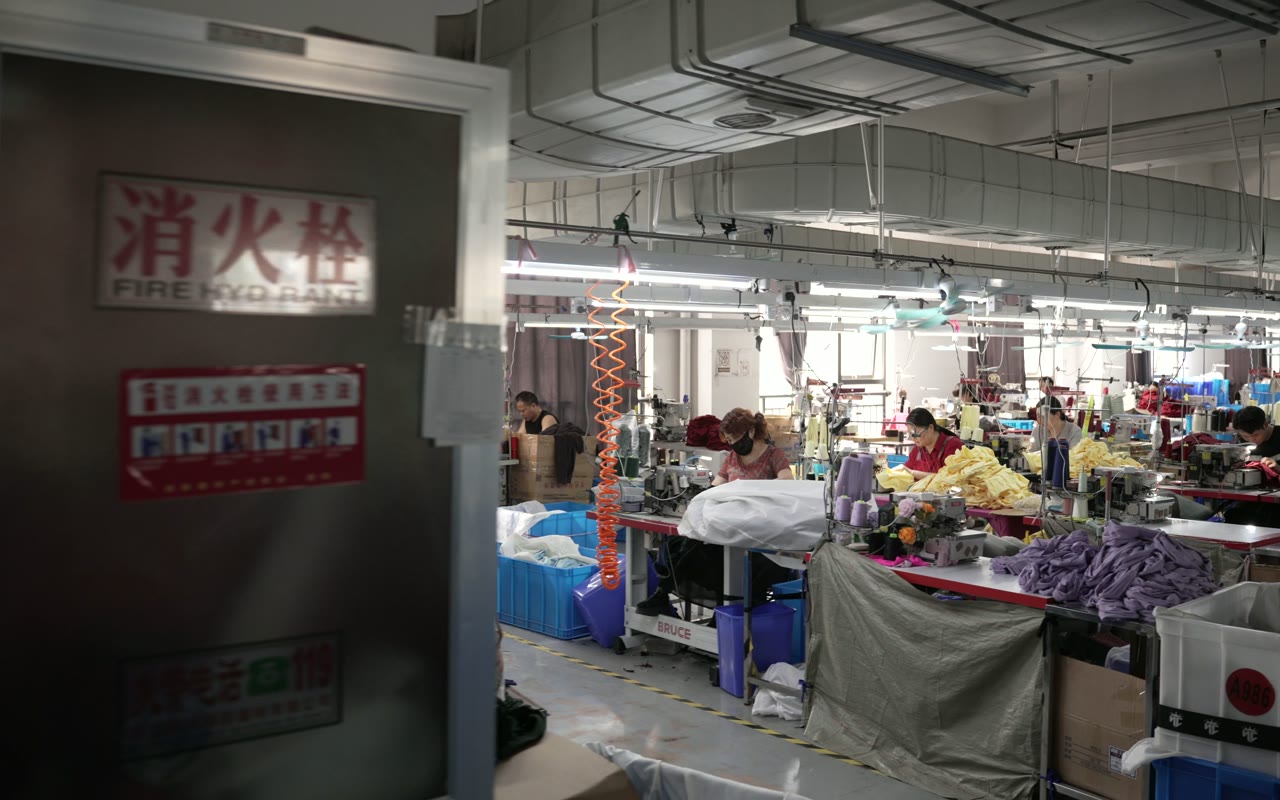 Garment production floor viewed across several active workstations