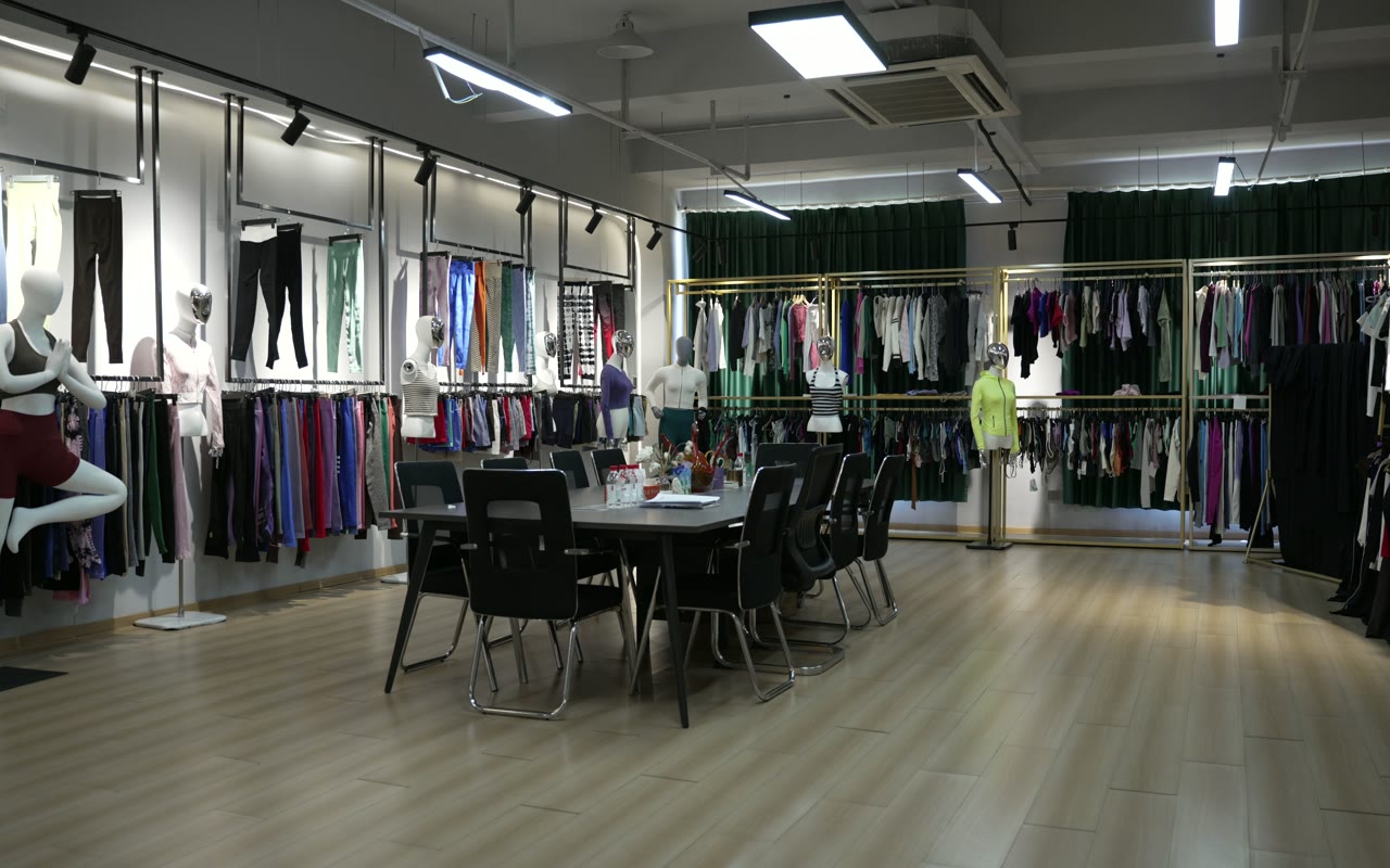 Wide product-reference room with activewear garments grouped along the walls