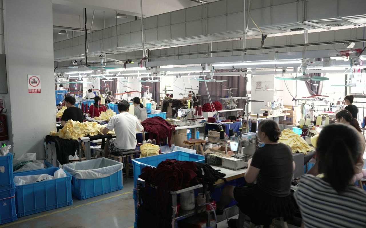 Garment workcell with operators, materials and work-in-progress containers